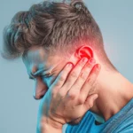 Man experiencing ear pain due to possible ear infection.