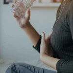 Medical illustration of red blood cells clotting and blocking an artery.