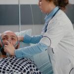 Medical professional treating a patient for severe shortness of breath, a potential emergency complication of GERD.