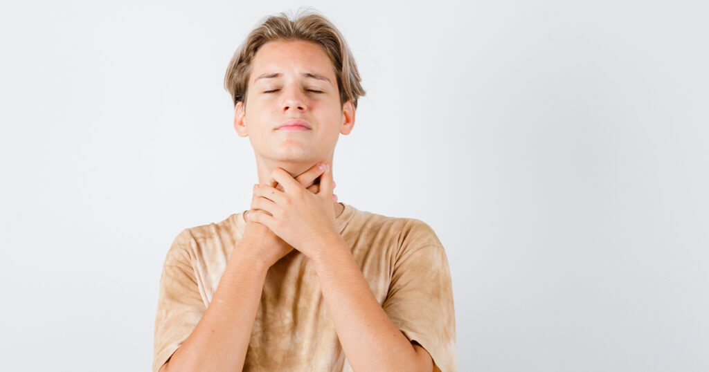 A man in Texas with his hands on his neck, appearing contemplative or in distress.