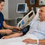 Nurse checking a patient’s blood pressure in hospital.
