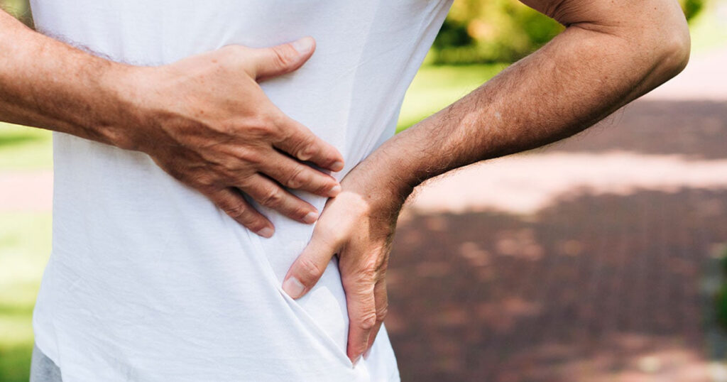 Man holding side with severe kidney pain