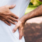 Man holding side with severe kidney pain